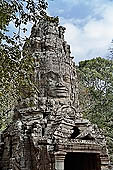 Ta Prohm temple - the temple west entrance, a well preserved gopura in the Bayon style with a tower with four faces of Lokesvara